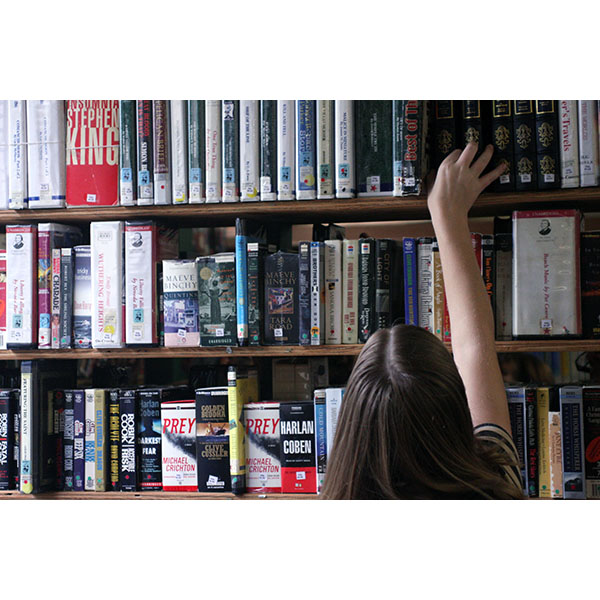 girl reaching for book